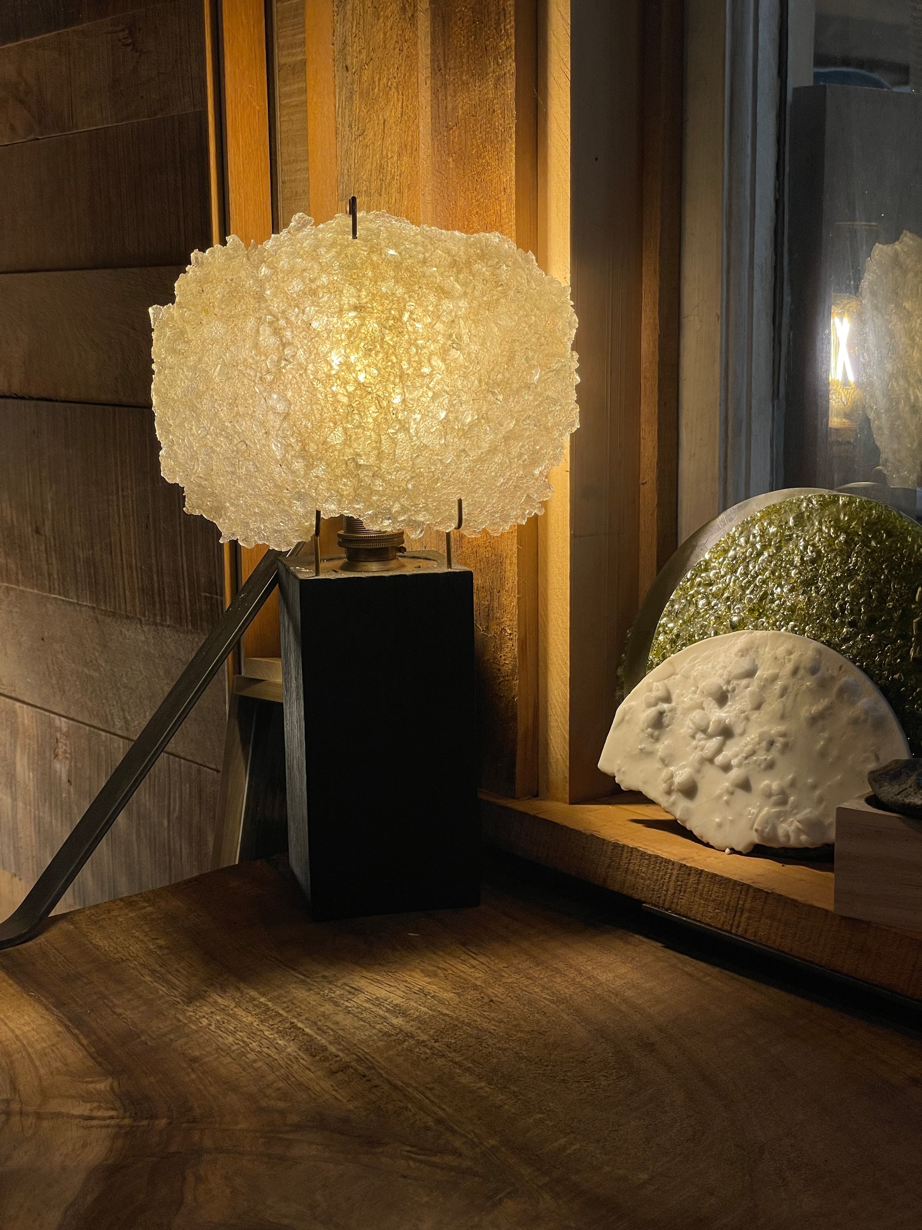 Illuminated experimental material lamp beside translucent samples